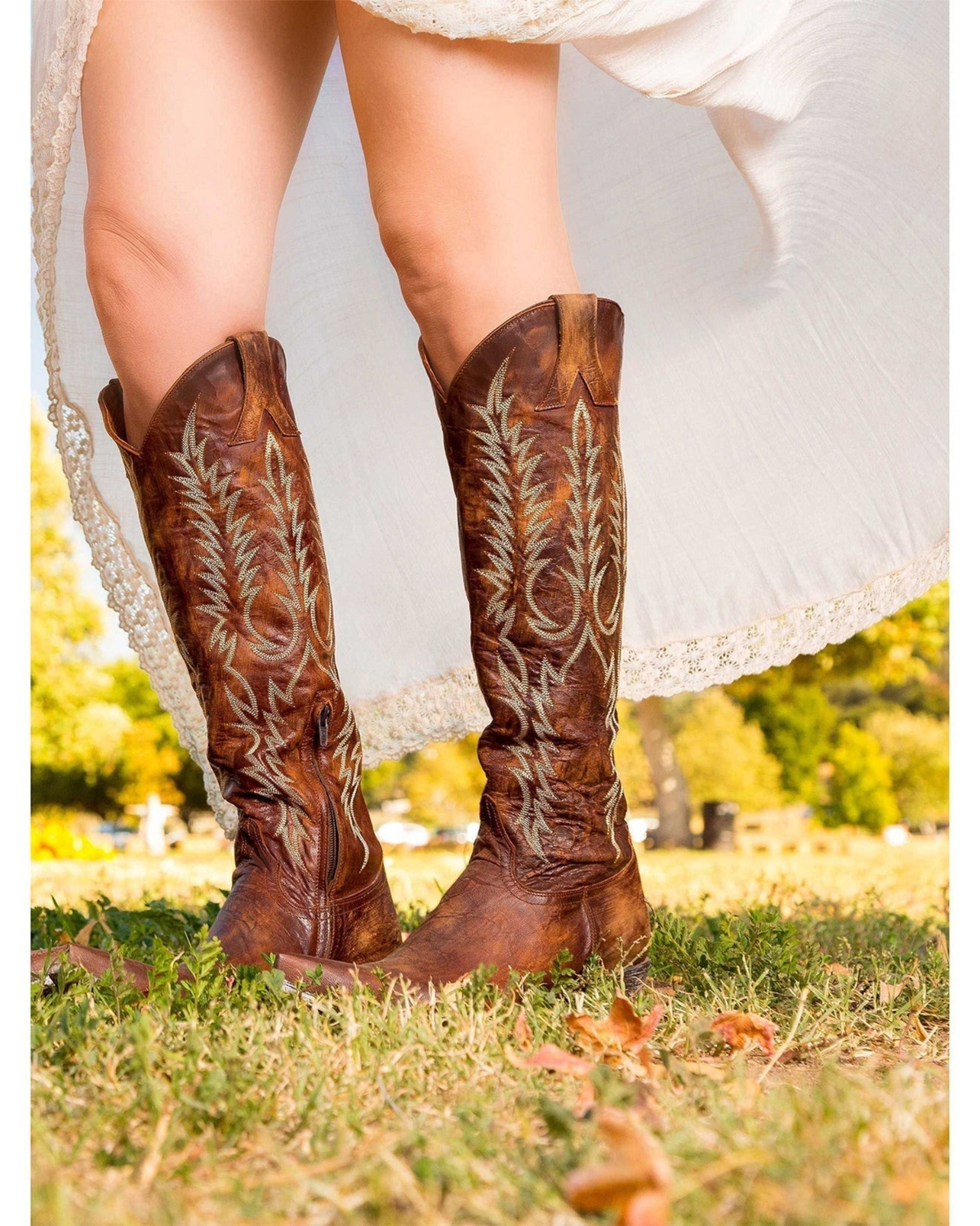 Old Gringo Boots Mayra brass goat leather tall western boots with intricate embroidery worn with a white dress